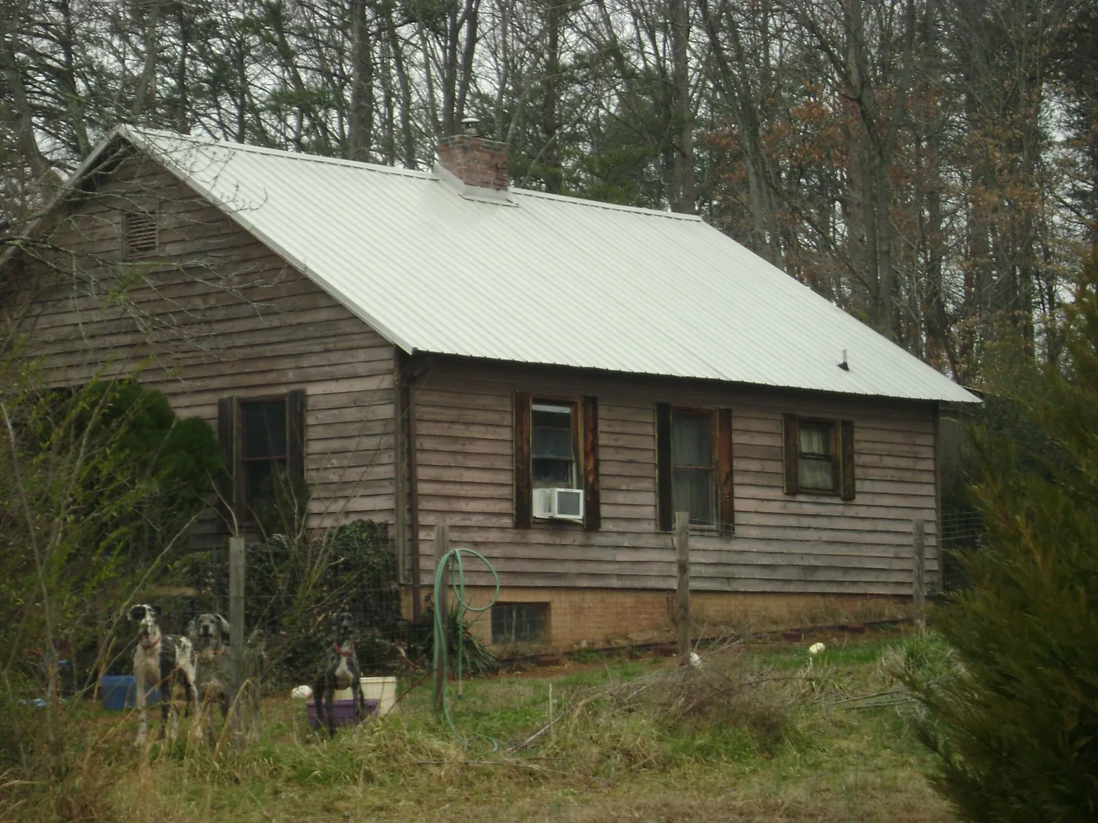 White metal roof on an old wood sided farmhouse, from a Metal Roof Installation job in Ironton